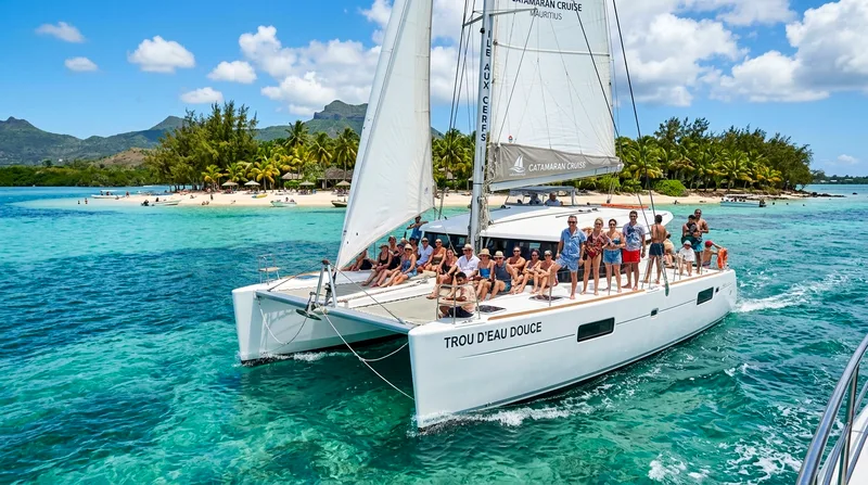 Catamaran cruise Trou d'Eau Douce approaching Île aux Cerfs island lagoon