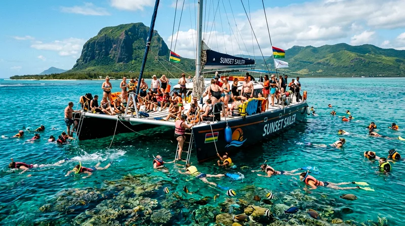 Group boat tour Mauritius catamaran crowded at coral reef snorkeling spot